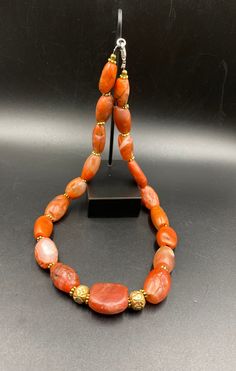 The Rare Unique PEMA RAKA Carnelian Amulet Prayer Beads Necklace From Himalayan Tibet The Age Of This Beads Are More than 1000 years Old As You Can See From Its Conditions Very Oily Smooth Skin Of This Pema Beads Some Gold Plated Wax and Gold Color Brass Beads Are Used As Spacers Rare Items For Collections Orange Agate Oval Beads Jewelry, Orange Agate Oval Beaded Jewelry, Hand-strung Agate Jewelry With Oval Beads, Hand-strung Oval Agate Bead Jewelry, Traditional Orange Gemstone Jewelry, Spiritual Orange Jewelry With Oval Beads, Traditional Hand-strung Agate Jewelry, Carnelian Amulet Jewelry With Round Beads, Traditional Oval Beads Agate Jewelry