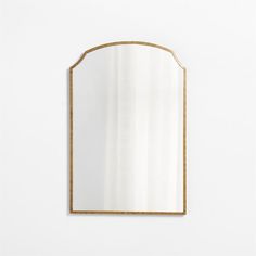 a gold framed mirror against a white wall