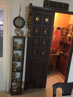 an open door to a room with clocks on the wall and other items in it