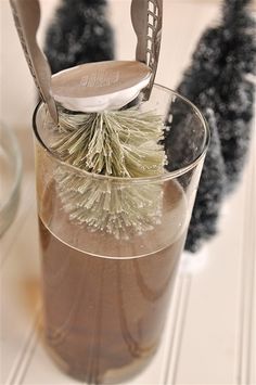 there is a toothbrush in a glass with ice