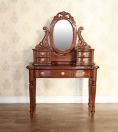 an antique wooden vanity with mirror and drawers