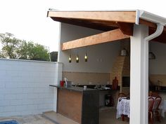 an outdoor kitchen and dining area is shown