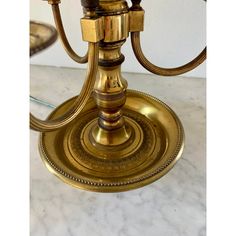 an antique brass candelabra with three candles