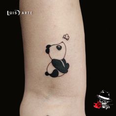 a small panda bear tattoo on the right side of the leg, with a heart in it's mouth