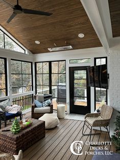 a living room filled with furniture and lots of windows