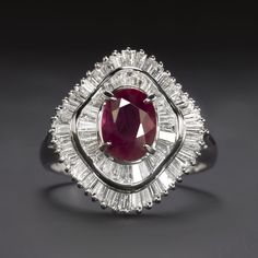 Why we love it: This gorgeous cocktail ring has a head turning look with a rich red ruby center and 1.04ct of glittering diamonds set in a cascading ballerina design! Overall this is a high quality piece with GIA certification, a high quality ruby center, substantial platinum setting and 1.04 carats of high quality diamonds! Highlights: - GIA Certification - 1.23ct ruby is excellent quality with a sought after geographic origin of Myanmar (Burma) - Ruby has gorgeous rich red color and a beautifu Diamond Ballerina Ring, Ballerina Design, Knife Edge Ring, Baguette Side Stones, Ballerina Ring, Gemstone Stacking Ring, Sapphire Eternity Ring, Ruby Birthstone, Stackable Wedding Bands