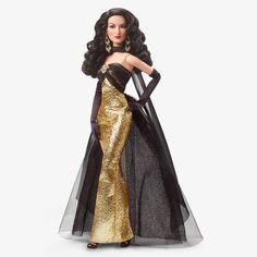 a barbie doll wearing a black and gold dress with long hair, in front of a white background