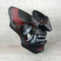 ⭐Name -  Samurai Mask 💥Application - Wearable mask, can be used as interior decoration 🎨Color - Black with red cracks 🖨️Production - 3D printing 🧵Material -Material - PLA plastic 🖌️Coloring - acrylic paints and varnishes. 🔒 Fastening -  2 adjustable elastic bands allow you to comfortably hold the mask on your head. 📏Internal size: width 155mm height 140mm Japanese Hannya Mask, Mouth Mask Design, Mask Wall Decor, Dark Mask, Demon Mask, Samurai Mask, Hannya Mask, 3d Printing Materials, Mask Wall