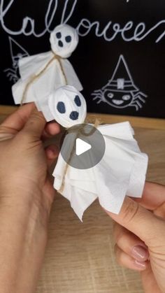 someone is making a paper ghost decoration