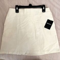 Off-White Mini Skirt From Forever 21 Never Been Worn Tags Still Attached, Size Medium. White Pencil Mini Skirt For Day Out, Forever 21 Fitted White Mini Skirt, Forever 21 Summer Pencil Mini Skirt, Forever 21 Pencil Mini Skirt For Summer, Forever 21 White Spring Bottoms, Forever 21 Summer Pencil Skirt, Forever 21 White Summer Skirt, Chic Forever 21 Cotton Skirt, Fitted White Mini Skirt By Forever 21