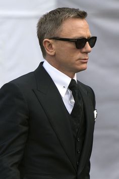 a man in a black suit and sunglasses