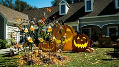 pumpkins and jack - o'- lantern decorations in front of a house