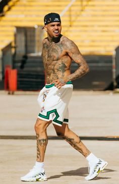 a man with tattoos and no shirt is running