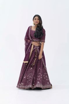 Plum Purple mirror work lehenga choli Matched with Purple mirror work blouse with quarter sleeves. Designed with round neck and has back hooks. Set together with a matching soft net purple duppata with mirror work and have gold border The length of the blouse is 14 inches. Blouse can fit a size 32 to 42 The maximum length of the lehenga will be 41 inches. Slight variation in color is possible due to digital photography. This is a 3 piece set. Care: dry clean only We provide side fitting/sleeves Festive Chinon Choli With Mirror Work, Purple Gota Work Dresses For Navratri, Purple Dola Silk Dupatta With Mirror Work, Purple Designer Dupatta With Mirror Work, Designer Purple Dupatta With Mirror Work, Purple Designer Wear Dupatta With Mirror Work, Festive Chanderi Lehenga With Mirror Work, Purple Dupatta With Mirror Work For Designer Wear, Dola Silk Lehenga With Mirror Work For Eid