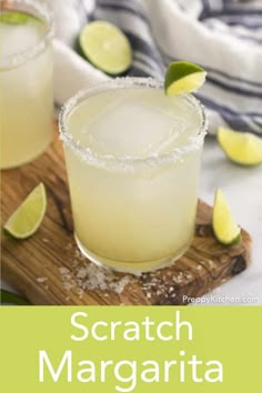 two margaritas sitting on top of a wooden cutting board with lime slices around them