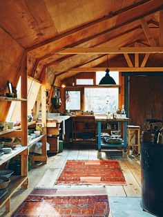 a room filled with lots of wooden furniture and rugs on top of flooring