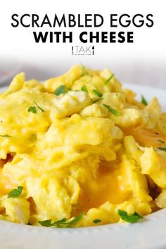 scrambled eggs with cheese on a white plate and text overlay that reads scrambled eggs with cheese