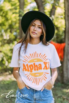 Looking for a trendy sorority tshirt that'll last? 🫶🏻 This Alpha Xi Delta Sunshine Tee is the answer! Whether you're giving this tee as a gift or treating yourself with something new, you'll be obsessed with this sorority t-shirt! 🌊 YOU'LL LOVE THIS STYLE 🌊 Meet the Alpha Xi Delta Sunshine Tee - the perfect t-shirt for sorority girls! Our basic tee is a classic style that looks great on everyone. The soft, breathable fabric makes it comfortable to wear all day long, and the bright white colo Summer Game Day T-shirt With Text Print, Pre-shrunk Sorority T-shirt With Crew Neck, Graphic Tee For Game Day In Spring, School Spirit T-shirt For Game Day In Spring, Spring Game Day Graphic Tee, Pre-shrunk Summer T-shirt For College, White Sorority T-shirt With Letter Print, White Sorority Tops With Letter Print, White Crew Neck Sorority T-shirt