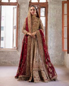 a woman in a red and gold bridal gown