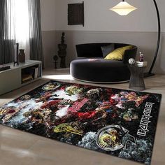 a living room with a large rug on the floor in front of a black couch