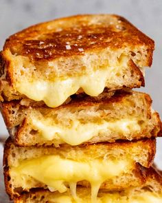 three grilled cheese sandwiches stacked on top of each other