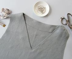 the apron is next to some scissors and a plate