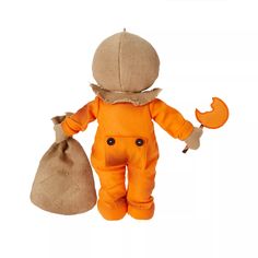 a stuffed animal with an orange overall and hat holding a bag full of money on a white background