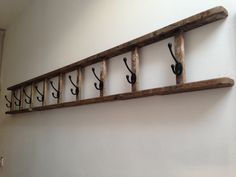 an old wooden shelf with hooks on it