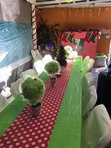 the table is covered with red and green cloths, which are decorated with pom poms