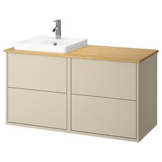 a white sink sitting on top of a wooden cabinet next to a faucet