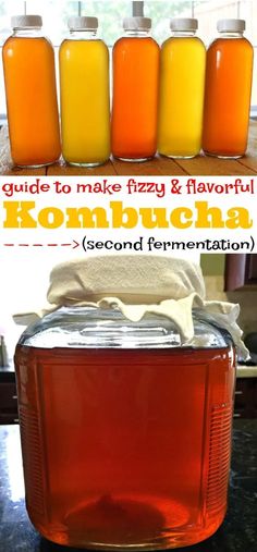 four jars filled with orange liquid and some white cloth on the counter next to each other