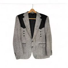 "Take your wardrobe up a notch with this vintage men's western yoke sport coat by Pagano West. Black and white tweed with black felt triangles for accent. Fully lined, button front closure with a back vent for added comfort when sitting or moving. Perfect fashion item for the western lifestyle. Tailored apparel made in USA. In excellent condition. * Vintage men's western yoke sport coat * Brand: Pagano West * Made in USA * Size: none listed * Fully lined  * Dry clean only * Length: 34\" (top of collar to hem) * Chest: 22\" (measurement taken from flat garment) * Sleeve outer: 25 1/2\"  * Sleeve inseam: 17\" * Two buttons for front closure * Fully lined * 2 flap pockets on front and 2 interior pockets * 12 felt triangles for added style (6 on front and 6 on back) * Age is estimate only * Vi Mens Western Sport Coat Size 42, Western Style Fitted Blazer For Fall, Fitted Winter Outerwear For Western-themed Events, Fitted Outerwear For Western-themed Winter Events, Fitted Western Blazer For Workwear, Rockabilly Long Sleeve Outerwear For Fall, Western Style Long Sleeve Fitted Blazer, Vintage Tailored Sport Coat With Welt Pockets, Vintage Semi-formal Long Sleeve Sport Coat