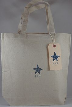 a white shopping bag with blue stars on the side and a tag hanging from it