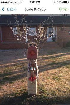 a parking meter in front of a red brick house with trees growing out of it