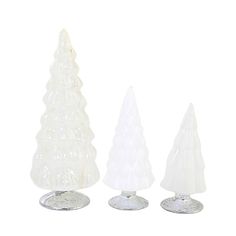 three white glass christmas trees sitting next to each other