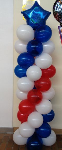 the balloon column is decorated with red, white and blue balloons