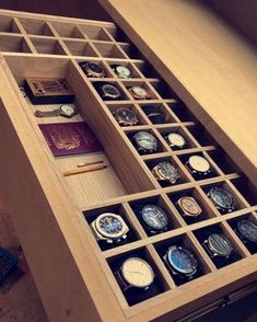 an open drawer with many different watches in it