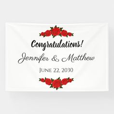 a white banner with red roses and the words congratulationss written in black on it