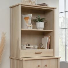 a wooden cabinet with drawers and books on top