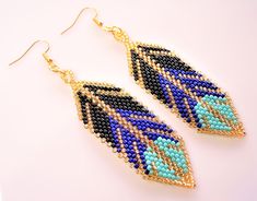 a pair of beaded earrings on a white surface