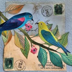 two birds sitting on top of a tree branch next to a mail envelope with leaves and flowers