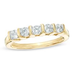 a yellow gold ring with five diamonds