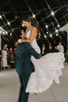 the bride and groom are dancing on the dance floor