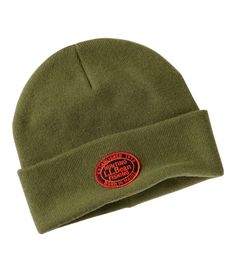 a green beanie hat with an orange patch on the front and red logo on the side