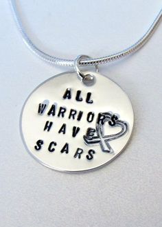 an all warriors have scars necklace on a white background