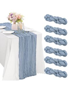 the table is set with blue napkins and place settings