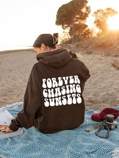 Chasing Sunsets Hoodie, Summer Hoodie, Brown Hoodie, Y2K Hoodie, Women Streetwear, Trendy Hoodie, Aesthetic Hoodie Gildan 18500 A unisex heavy blend hooded sweatshirt is relaxation itself. The material is a thick blend of cotton and polyester. This makes for a plush, soft feel alongside warmth. It's also a great surface for printing. There are no side seams. A spacious kangaroo pocket hangs in front. The hood's drawstring is the same color as the base sweater.  * Available hoodie sizes: S -5XL * Sunset Hoodie, Under The Same Moon, Summer Hoodie, Vsco Hoodie, Positive Hoodie, Aesthetic Hoodies, Beach Hoodie, Chasing Sunsets, Hoodie Aesthetic