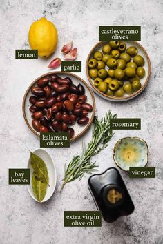 olives and lemons are shown in bowls on a table with labels for different types of olives