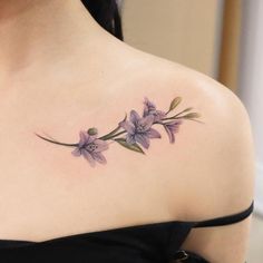 a woman with a flower tattoo on her shoulder