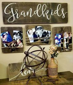 three wooden pictures hanging on a wall next to a vase with flowers and a wire sculpture